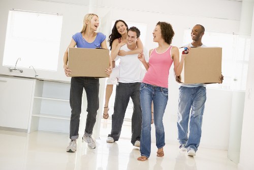 Professional packers organizing household boxes in a French apartment